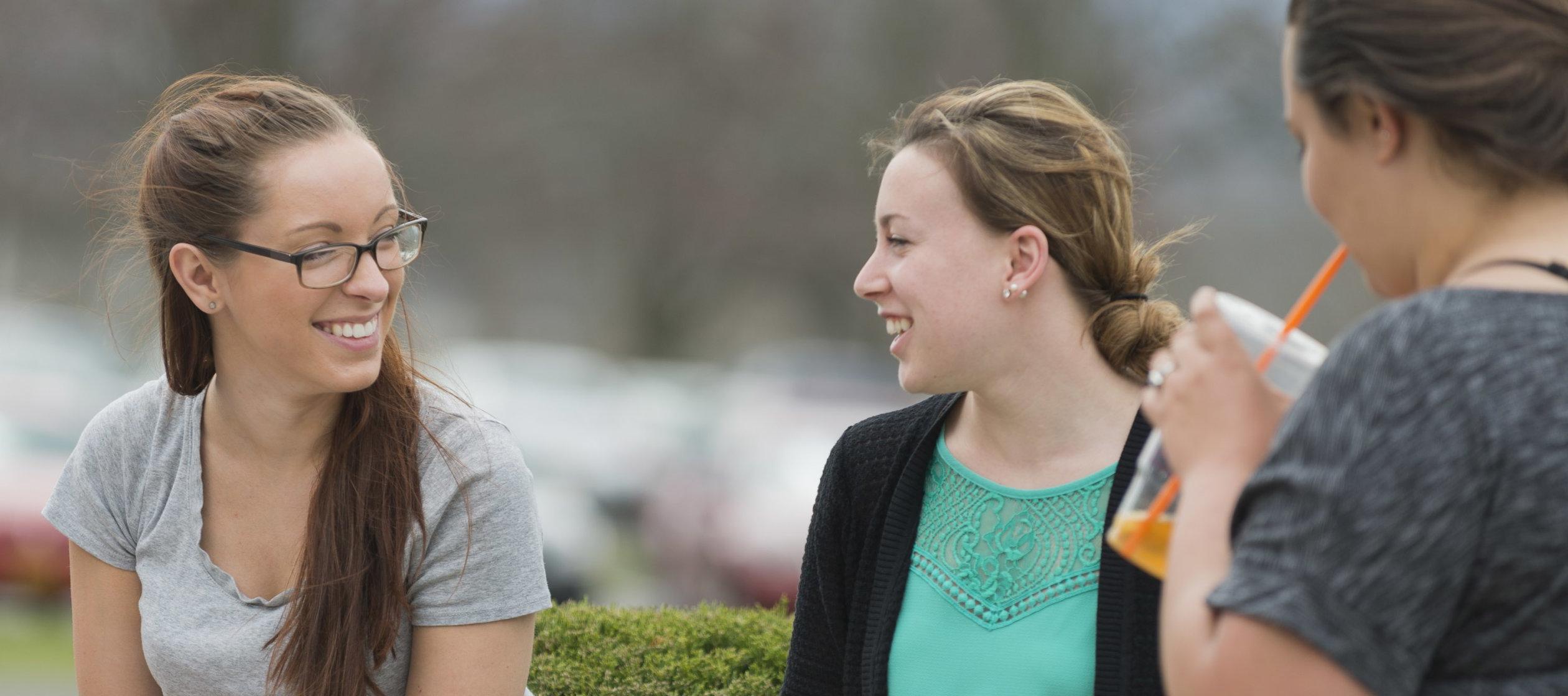 Campus Scenic - Students Talking by bushes - Spring 062